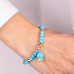 Bracciale in Metallo con campanella smaltata turchese e perline