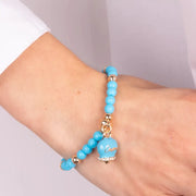 Bracciale in Metallo con campanella smaltata turchese e perline