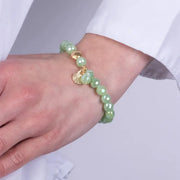 Bracciale in Metallo con sfere verdi e ciondolo conchiglia