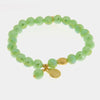 Bracciale in Metallo con sfere verdi e ciondolo conchiglia