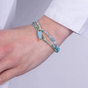 Bracciale in Metallo con perline azzurre e ciondolo pesciolino