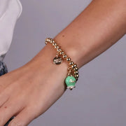 Bracciale in Metallo con campanella verde  scritta capri