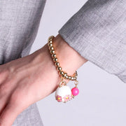 Bracciale in Metallo con campanella bianca e  fiori e perla