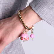 Bracciale in Metallo con campanella rosa e  fiori e perla
