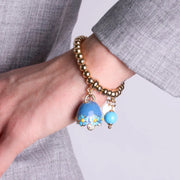 Bracciale in Metallo con campanella blu e  fiori e perla