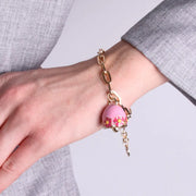 Bracciale in Metallo con campanella rosa e  fiori