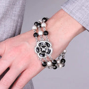 Bracciale in Metallo multifilo con fiore nero e perle bianche