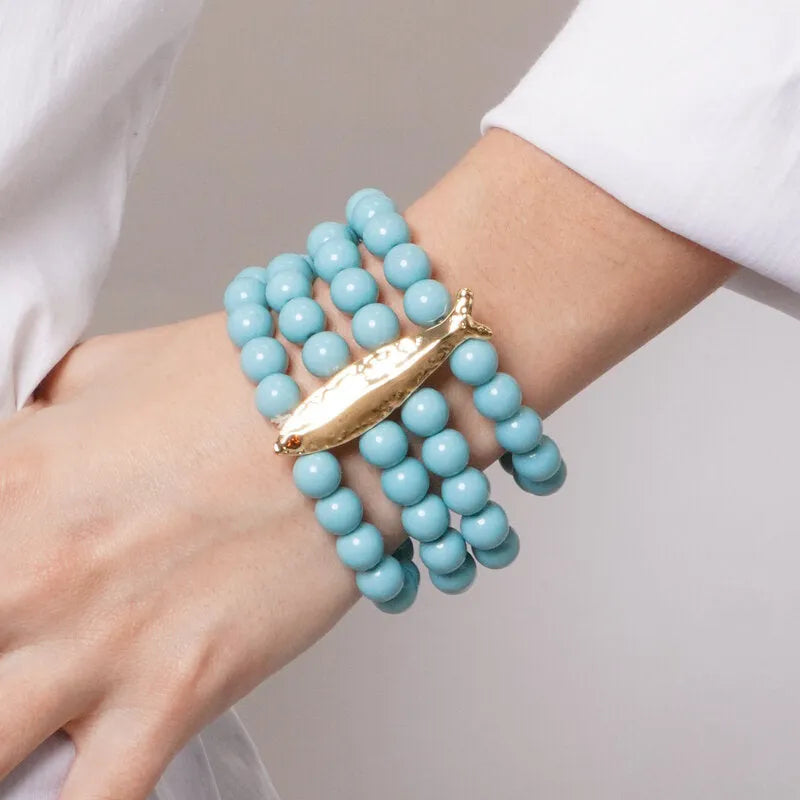 Metal bracelet with turquoise beads and fish with hammered finishes