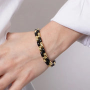 Bracciale in Metallo elastico con maglie lisce in nero e oro