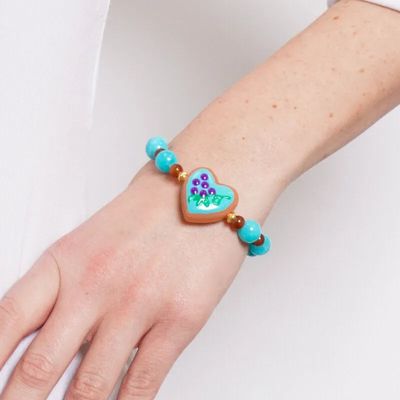 Bracciale in Metallo elastico con cuore turchese e perle rosse e azzurre