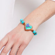Bracciale in Metallo elastico con cuore turchese e perle rosse e azzurre
