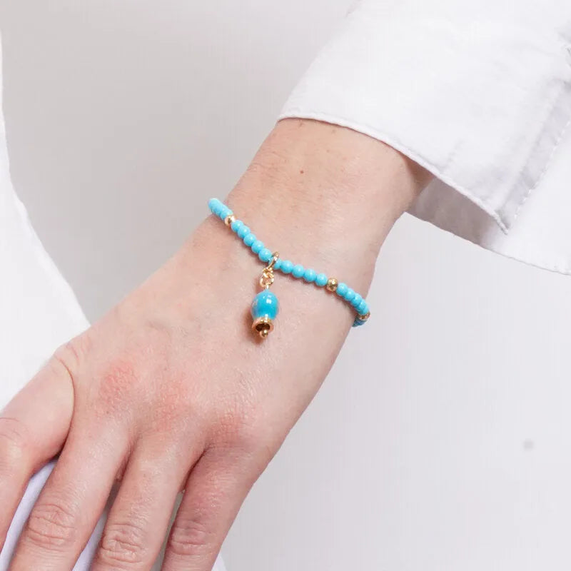 Bracciale in Metallo con filo di sfere azzurre e campanella azzurra con scritta capri