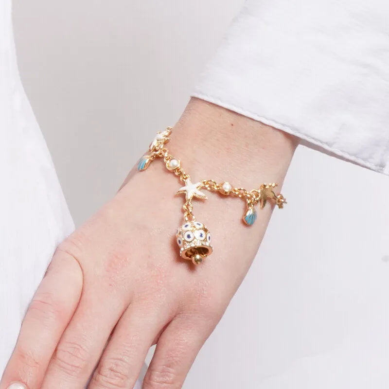 Bracciale in Metallo con campanella dorata e blu con cristalli in rilievo e stelle marine con conchiglie