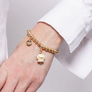 Bracciale in Metallo con campanella portafortuna crema e cristalli