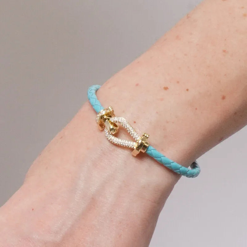 Bracciale in Metallo simil pelle intrecciata turchese con chiusura gioiello dorata