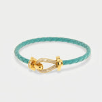 Bracciale in Metallo simil pelle intrecciata turchese con chiusura gioiello dorata - BYSIMON gioielli