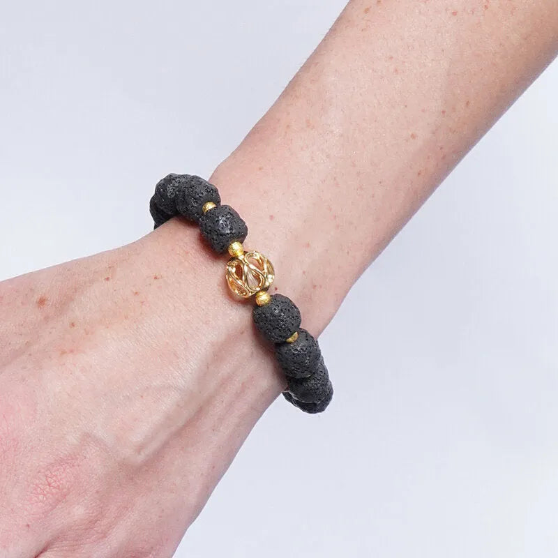 Bracciale in Metallo elastico con sfere laviche nere e dorata