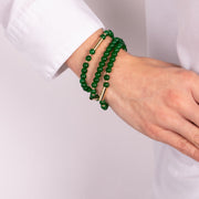Multi-strand metal bracelet with green stones