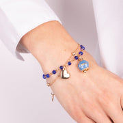 Multi-strand metal bracelet with blue stones and blue Capri bell