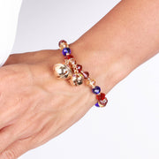 Metal bracelet with rattles and colored stones
