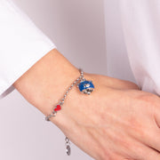 Metal bracelet with blue bear-shaped bell and red heart