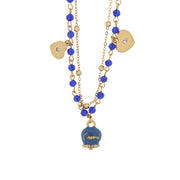 Multi-strand metal necklace with blue stones and blue Capri bell