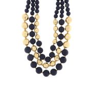 Multi-strand metal necklace with blue and golden stones