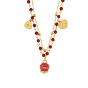 Multi-strand metal necklace with fuchsia bell and red stones