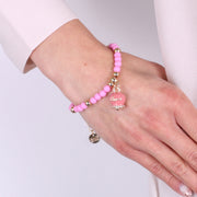 Bracciale in Metallo con campanella pendente e perline rosa
