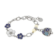 Metal bracelet with bell and blue and white flowers